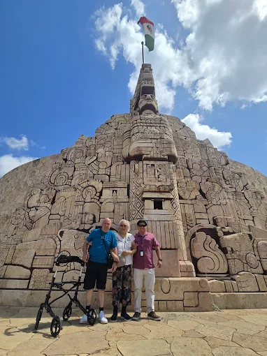 a group of people standing in front of a stone structure